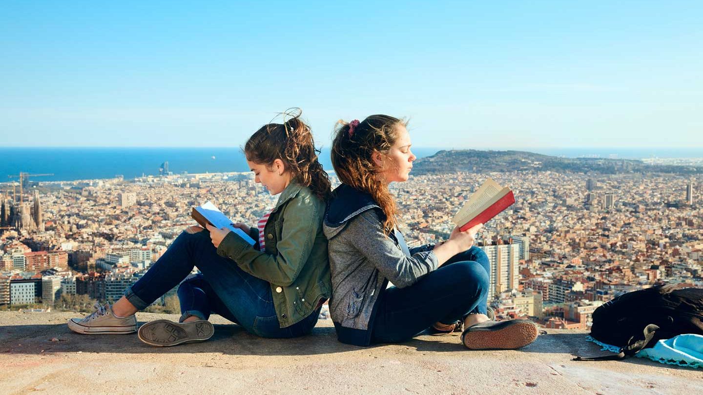 Students sitting in abroad reading books.